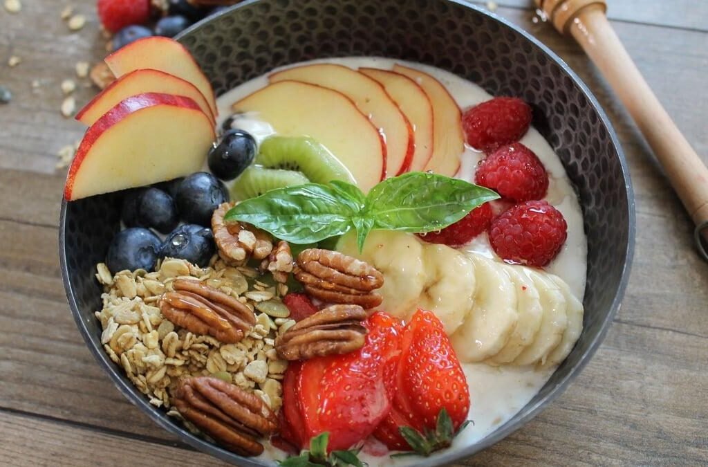 Fruit and yogurt breakfast bowl with fresh fruit and nuts